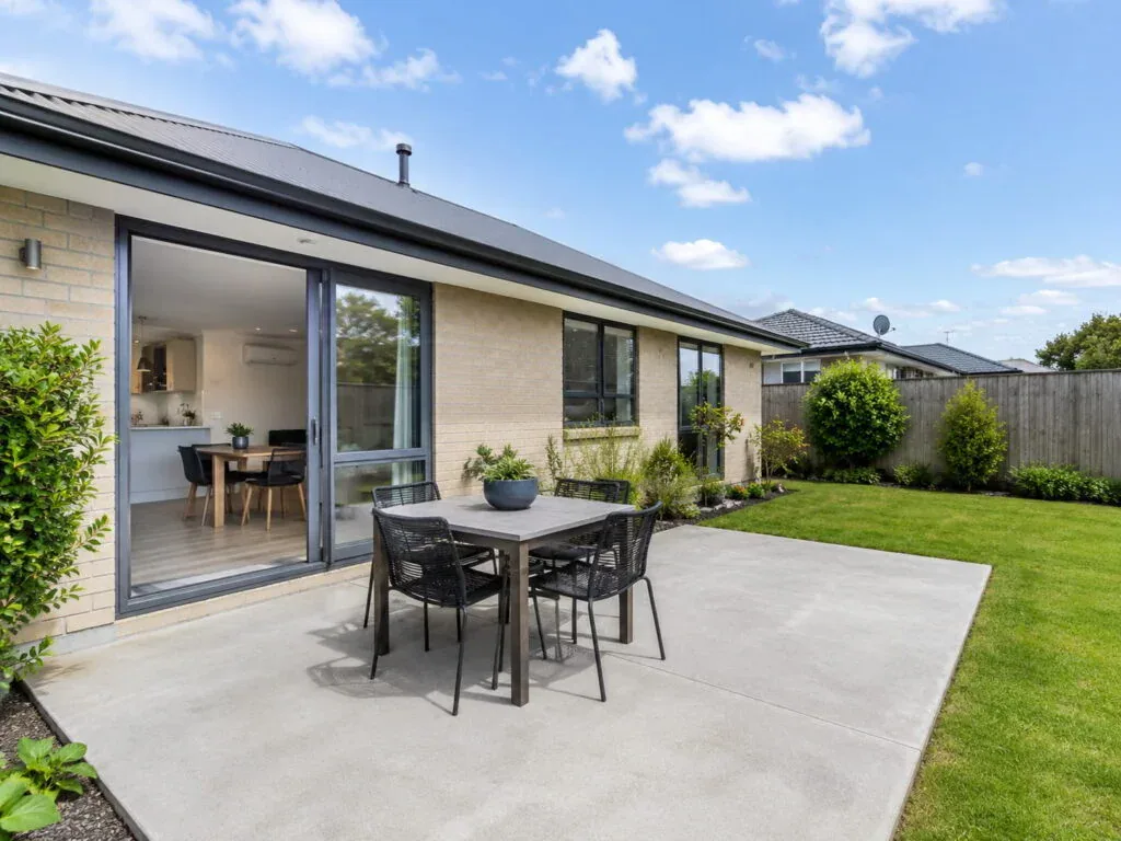 Concrete patio poured off a dining room slider in Christchurch